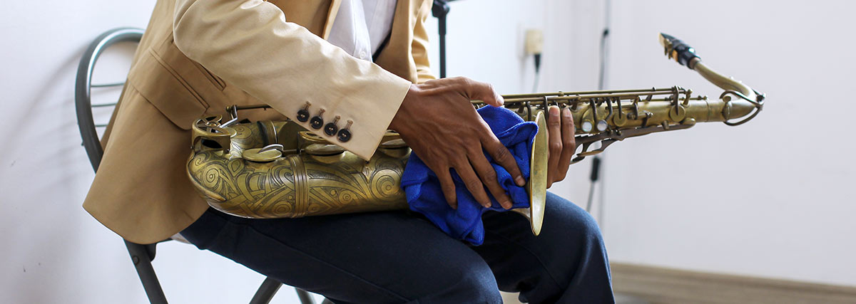 Reinigung eines Saxophons mit einem Mikrofasertuch zur regelmäßigen Pflege und Wartung des Instruments