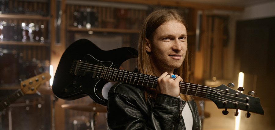 Man with an electric guitar over his shoulder