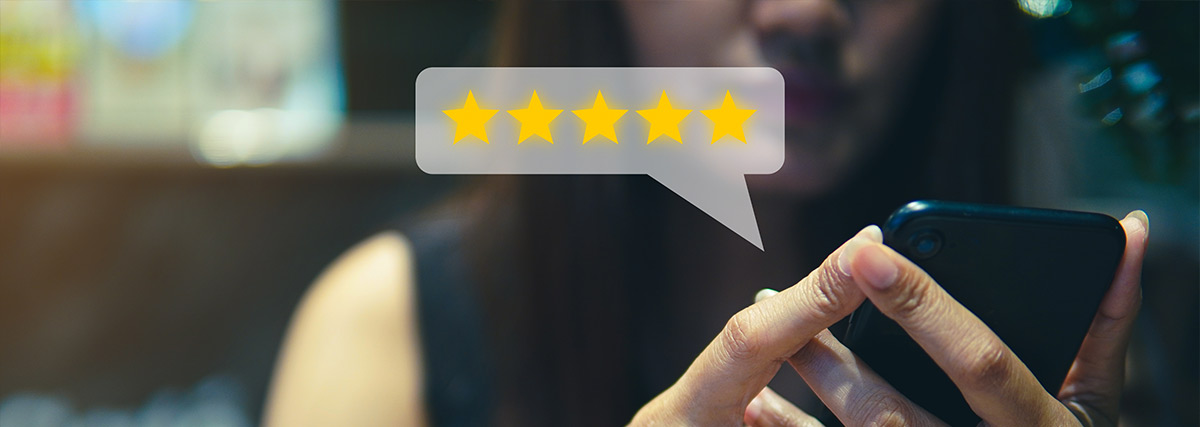 Woman with smartphone giving a 5-star review