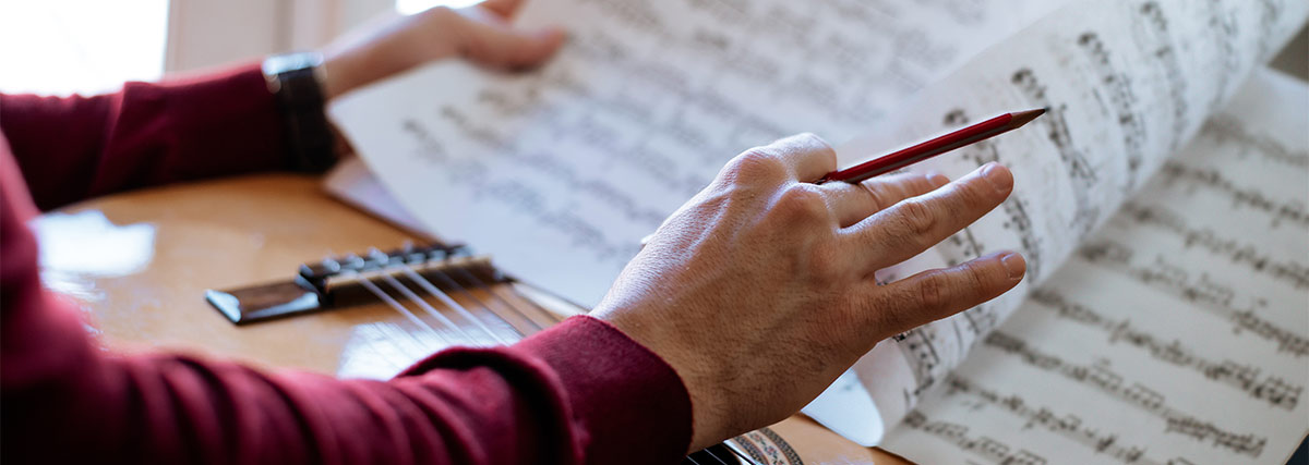 Hands turning sheet music pages