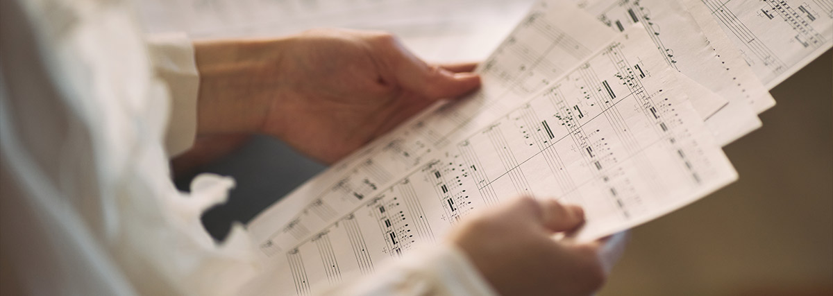 Hands holding sheet music