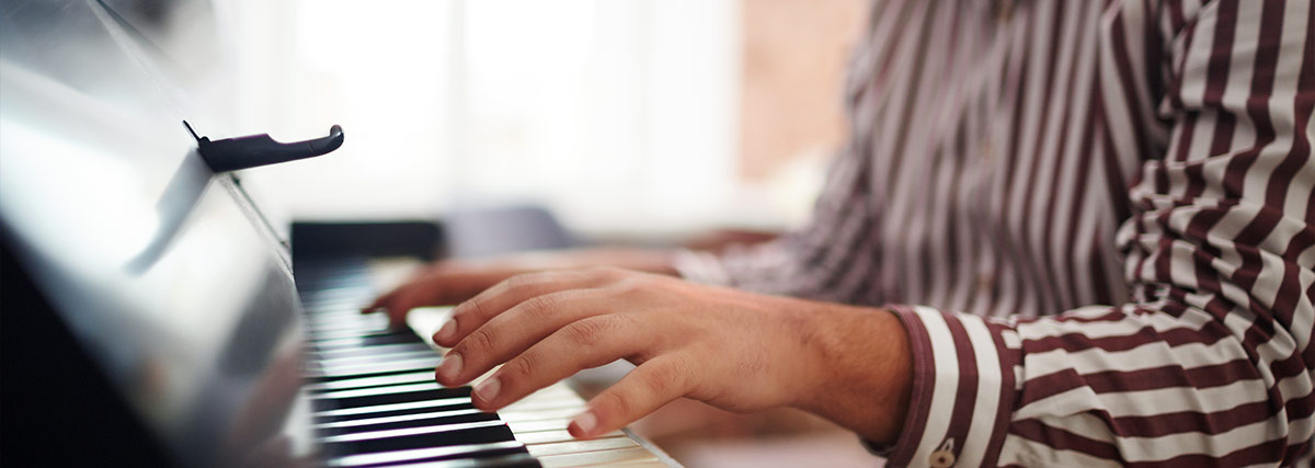 Male hands playing the piano