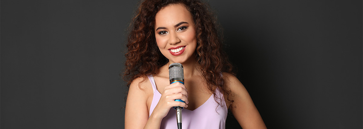 Smiling woman holding a microphone